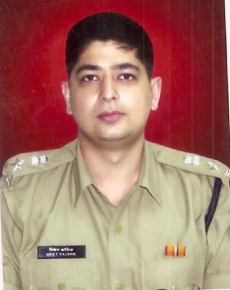 Archival service photograph of Niket Kaushik in Maharashtra Police uniform earlier in his career, name plate visible on the tunic.