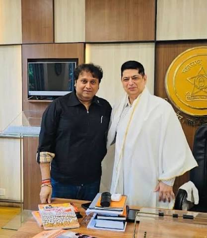 Niket Kaushik, IPS, in his office during a visit, with files and papers on the desk in front of him.
